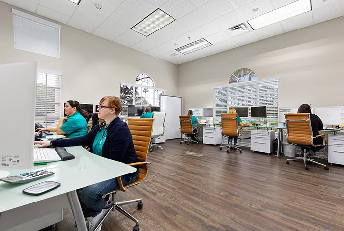 Florida Vacation Homes team providing property management and guest support services in office