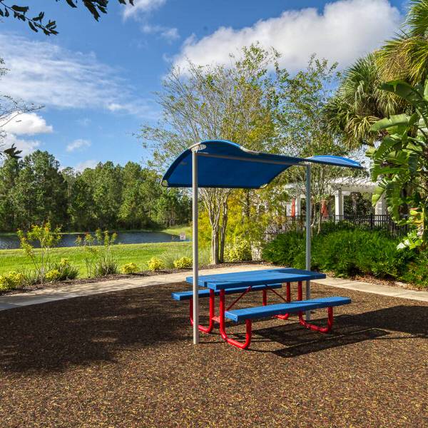 Shaded picnic area at Watersong Resort in Davenport Florida with outdoor seating and lake views