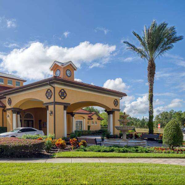 Clubhouse entrance at Watersong Resort Davenport Florida featuring fountain and tropical landscaping
