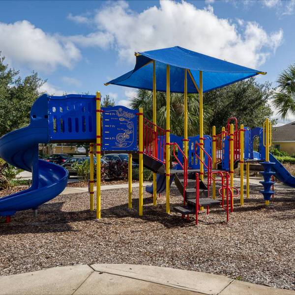 Children’s playground at Watersong Resort in Davenport Florida with slides climbing area and shaded play structure