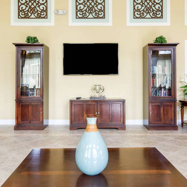 Watersong Resort clubhouse lounge area with TV, seating, and decorative furnishings in Davenport Florida