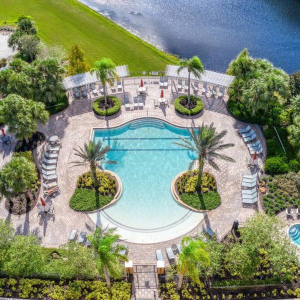 Aerial view of watersong resort orlando vacation homes clubhouse pool with lake views