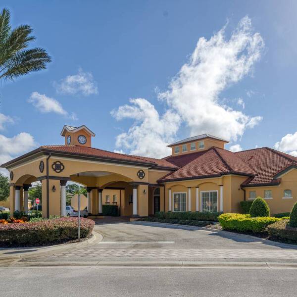 Watersong Resort clubhouse in Davenport Florida with covered entrance and landscaped surroundings