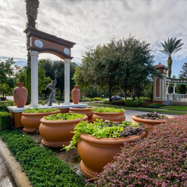 Watersong Resort entrance feature in Davenport Florida with decorative fountain sculpture and landscaped planters