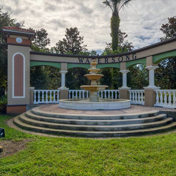 Resort-style fountain and entrance feature at Watersong Davenport Florida with columns and tropical landscaping