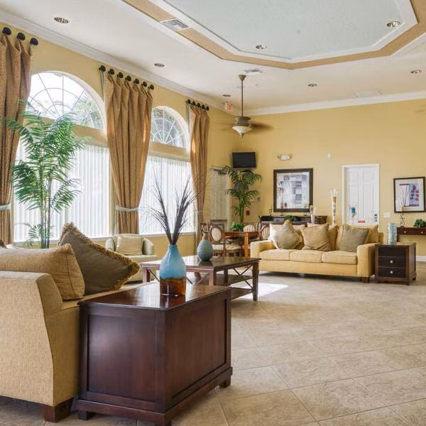 Watersong clubhouse lounge with sofas, side tables and tall windows