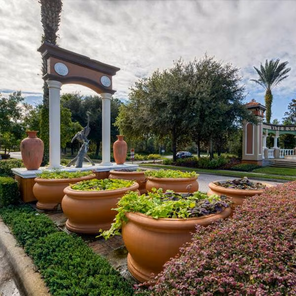 Watersong Resort entrance feature in Davenport Florida with decorative fountain sculpture and landscaped planters