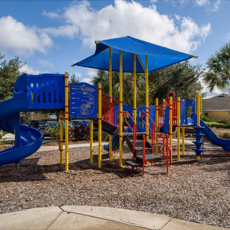Playground at Watersong Resort in Davenport Florida with slides and shaded play area