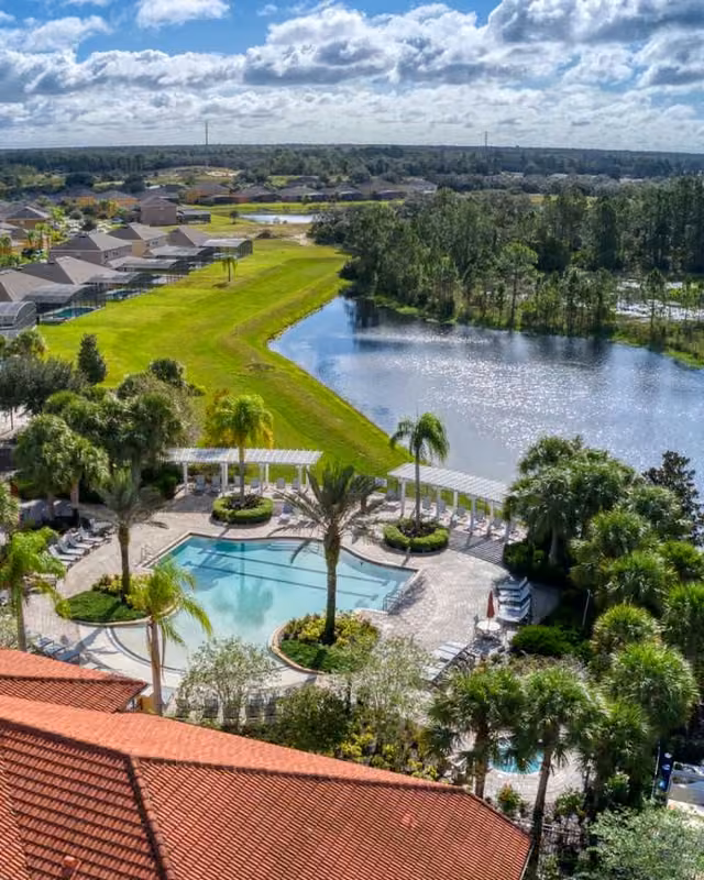 Aerial view of Watersong Resort clubhouse, swimming pool and lake in Davenport, Florida